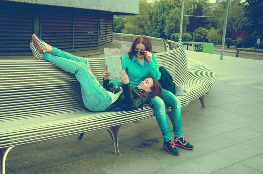 tourists resting on a bench photo