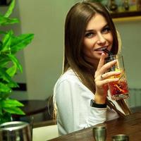 young sexual woman drinks cocktail photo