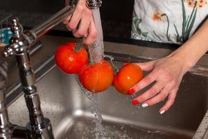 The girl is preparing vegetables for processing photo