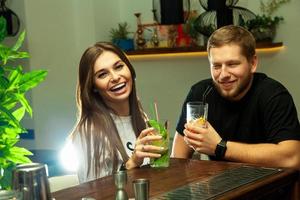 Girl with a guy at the bar laughing photo