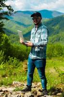 man working on laptop in the mountains photo