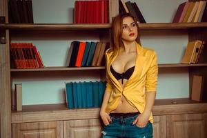 charming girl in a yellow jacket looking away photo