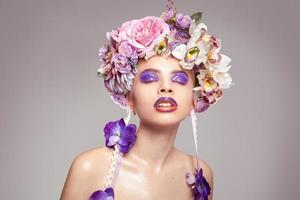 woman with wreath on head and makeup in purple tones photo