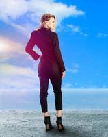 blonde lady in black business suit on high heels photo