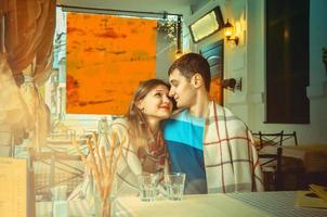 couple on a date at the restaurant looking at each other photo