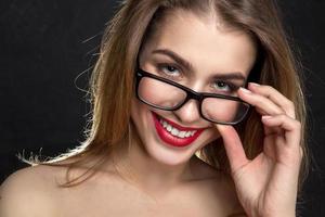 woman with red lips and glasses smiling photo