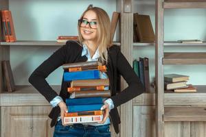 Beautiful girl in the library with books photo