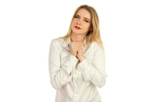 girl in a white shirt squeezes hands photo