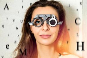 beautiful girl checks vision in an ophthalmologist with corrective lenses photo