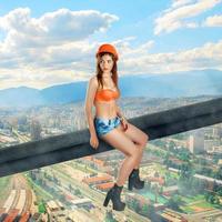 woman builder sits on a crossbar photo