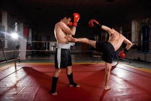 Two men is boxing on the ring photo