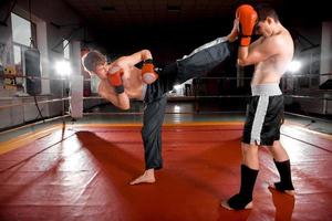 Two men is boxing on the ring photo