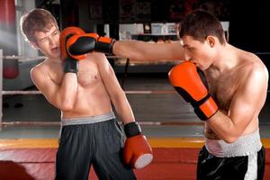 Two men is boxing on the ring photo