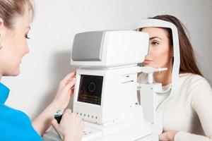 ophthalmologist checks vision to her patient photo