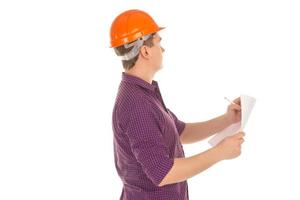 builder in hardhat with plan in hands photo