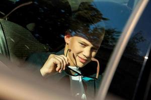 boy in sunglasses on the backseat photo