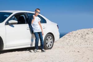 handsome young boy in sunglasses photo