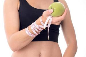 close-up of a young girl who is holding an apple in his hand photo