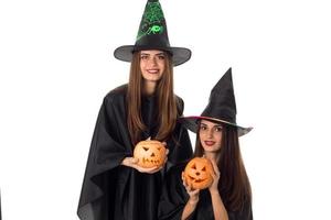 beautiful young women with pumpkins in hands photo