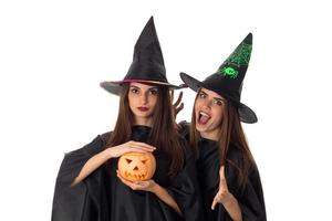 joyful young women with pumpkins in hands photo