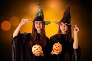 beauty young girls with pumpkins in hands photo