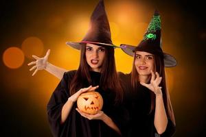 young beautiful women with pumpkins in hands photo