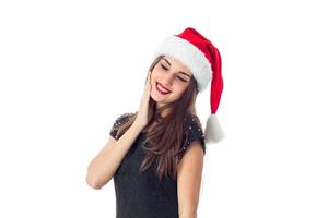 girl in santa hat with closed eyes photo