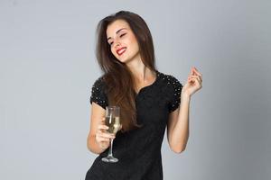 girl in black dress posing in studio photo