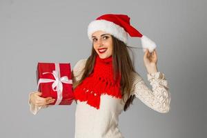 chica con sombrero de santa con regalo foto