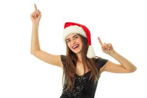 portrait of cheerful lovely woman in santa hat photo