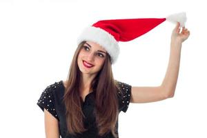 young brunette girl in santa hat photo