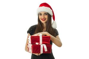 Handsome girl in santa hat with red gift photo