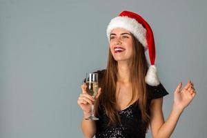 Happy lovely woman in santa hat photo