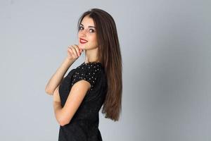 girl in black dress posing in studio photo