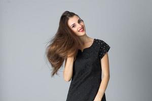 girl in black dress posing in studio photo
