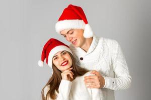 couple in love celebrates christmas in santa hat photo