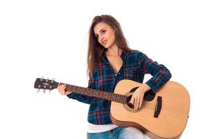 attractive brunette girl playing guitar photo