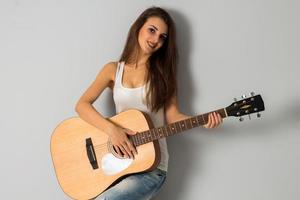 sexy woman with big breasts and guitar in hands photo