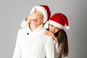 couple in love celebrates christmas in santa hat photo