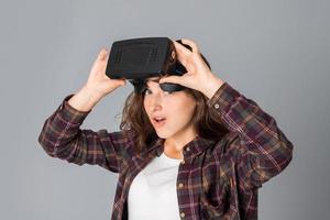 young girl testing virtual reality glasses photo