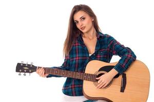 gorgeous brunette girl playing guitar photo