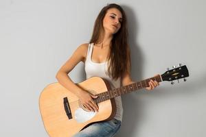 sexual woman with big breasts and guitar in hands photo