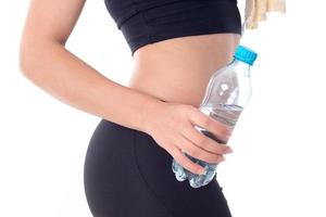 Sports girl holding a bottle of water in his hand photo