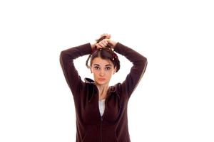 pretty young girl in brown sport clothes looking at the camera and posing isolated on white background photo