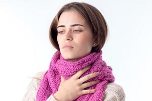 young girl caught a cold and keeps the scarf on the neck photo