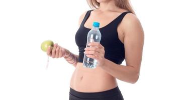 close-up of a slender girl who is turned sideways and holding an apple photo