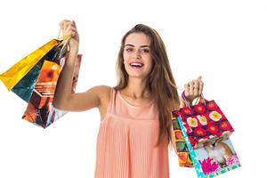 fun pretty girl holds many different packages with gifts and laughs close-up photo