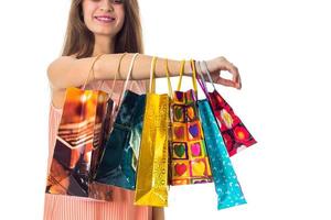 girl have placarded on hand many bright gift packages close-up photo