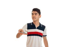 cheerful young brunett man playing ping-pong isolated on white background photo