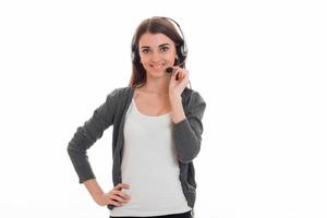 cheerful young brunette call office worker woman with headphones and microphone smiling on camera isolated on white background photo